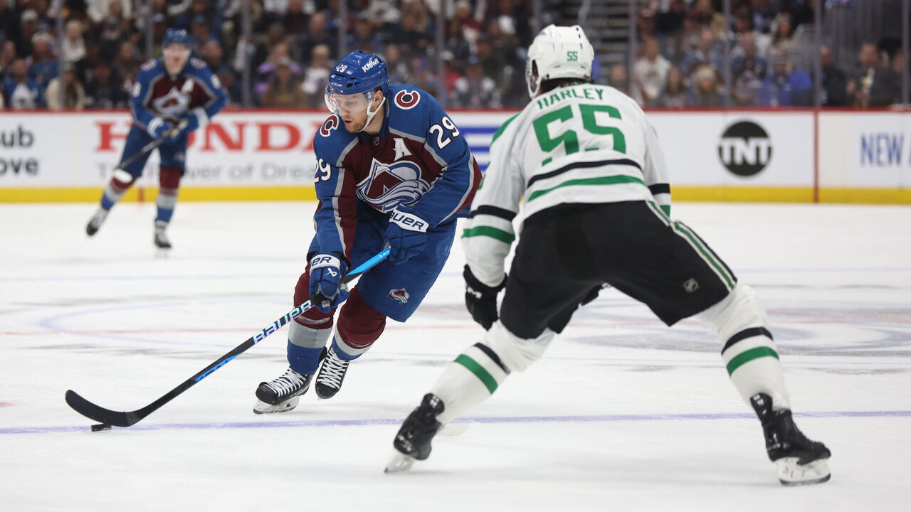 DENVER, COLORADO - MAY 11: Nathan MacKinnon #29 of the Colorado Avalanche skates with the puck against Thomas Harley #55 of the Dallas Stars during the second period in Game Three of the Second Round of the 2024 Stanley Cup Playoffs at Ball Arena on May 11, 2024 in Denver, Colorado.