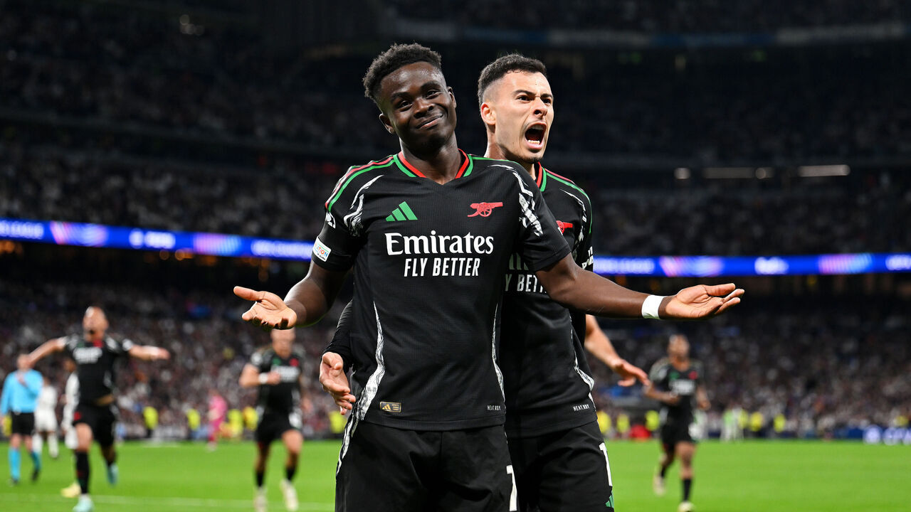 MADRID, SPAIN - APRIL 16: Bukayo Saka of Arsenal celebrates scoring his team's first goal with teammate Gabriel Martinelli during the UEFA Champions League 2024/25 Quarter Final Second Leg match between Real Madrid C.F. and Arsenal FC at Estadio Santiago Bernabeu on April 16, 2025 in Madrid, Spain.