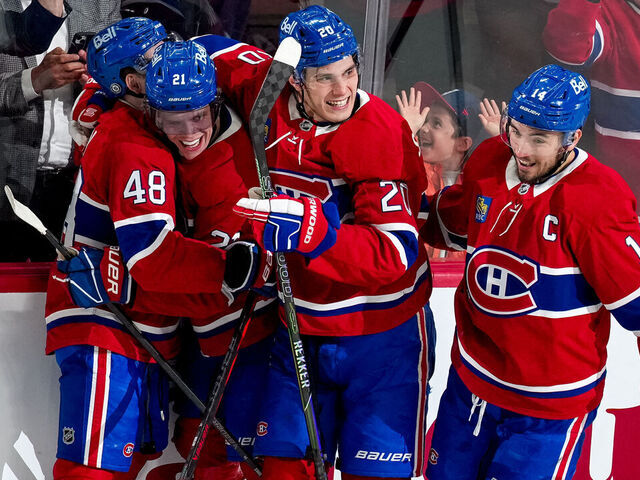 MONTREAL, QUEBEC - APRIL 16: Kaiden Guhle #21 of the Montreal Canadiens celebrates his goal with teammates Lane Hutson #48, Juraj Slafkovský #20 and Nick Suzuki #14 during the second period against the Carolina Hurricanes at Bell Centre on April 16, 2025 in Montreal, Quebec.