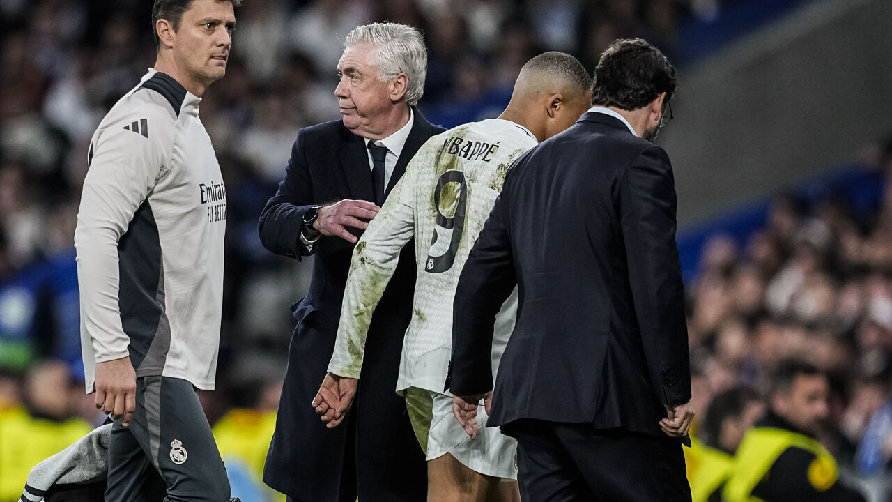 MADRID, SPAIN - APRIL 16: Kylian Mbappe is injured greets Carlo Ancelotti, head coach of Real Madrid during the UEFA Champions League 2024/25 Quarter Final Second Leg match between Real Madrid C.F. and Arsenal FC at Santiago Bernabeu stadium on April 16, 2025, in Madrid, Spain.