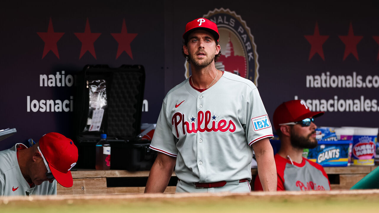 WASHINGTON, DC - MARCH 30: Aaron Nola #27 of the Philadelphia Phillies looks on from the dugout after leaving the game during the sixth inning against the Washington Nationals at Nationals Park on March 30, 2025 in Washington, DC.