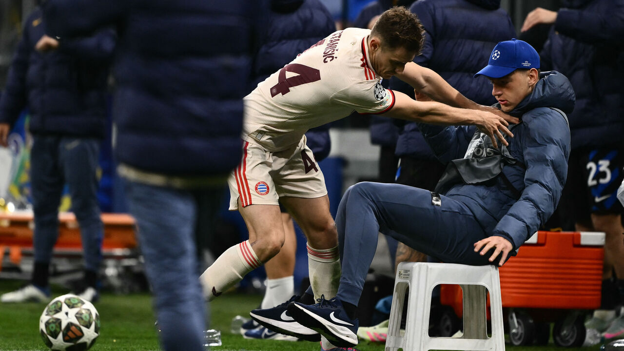 Bayern Munich's Croatian defender #44 Josip Stanisic pushes a ball boy during the UEFA Champions League quarter final second leg football match between Inter Milan and Bayern Munich at the San Siro stadium in Milan on April 16, 2025.