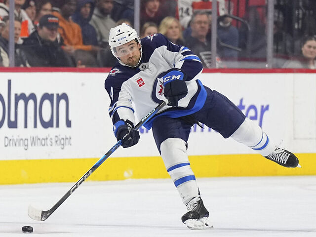 PHILADELPHIA, PENNSYLVANIA - MARCH 6: Neal Pionk #4 of the Winnipeg Jets controls the puck against the Philadelphia Flyers at the Wells Fargo Center on March 6, 2025 in Philadelphia, Pennsylvania. The Jets defeated the Flyers 4-1.
