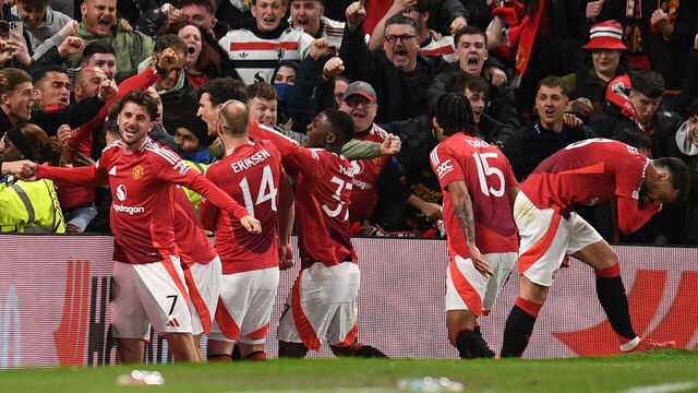 Manchester United's English defender #05 Harry Maguire (C) and teammates celebrate with their fans after Maguire scores their fifth goal during the UEFA Europa league quarter-final final, second leg football match between Manchester United and Lyon at Old Trafford stadium in Manchester, north west England, on April 17, 2025.