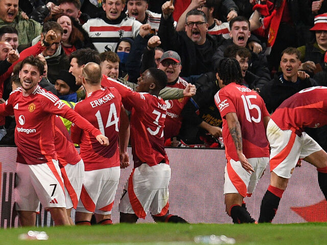 Manchester United's English defender #05 Harry Maguire (C) and teammates celebrate with their fans after Maguire scores their fifth goal during the UEFA Europa league quarter-final final, second leg football match between Manchester United and Lyon at Old Trafford stadium in Manchester, north west England, on April 17, 2025.