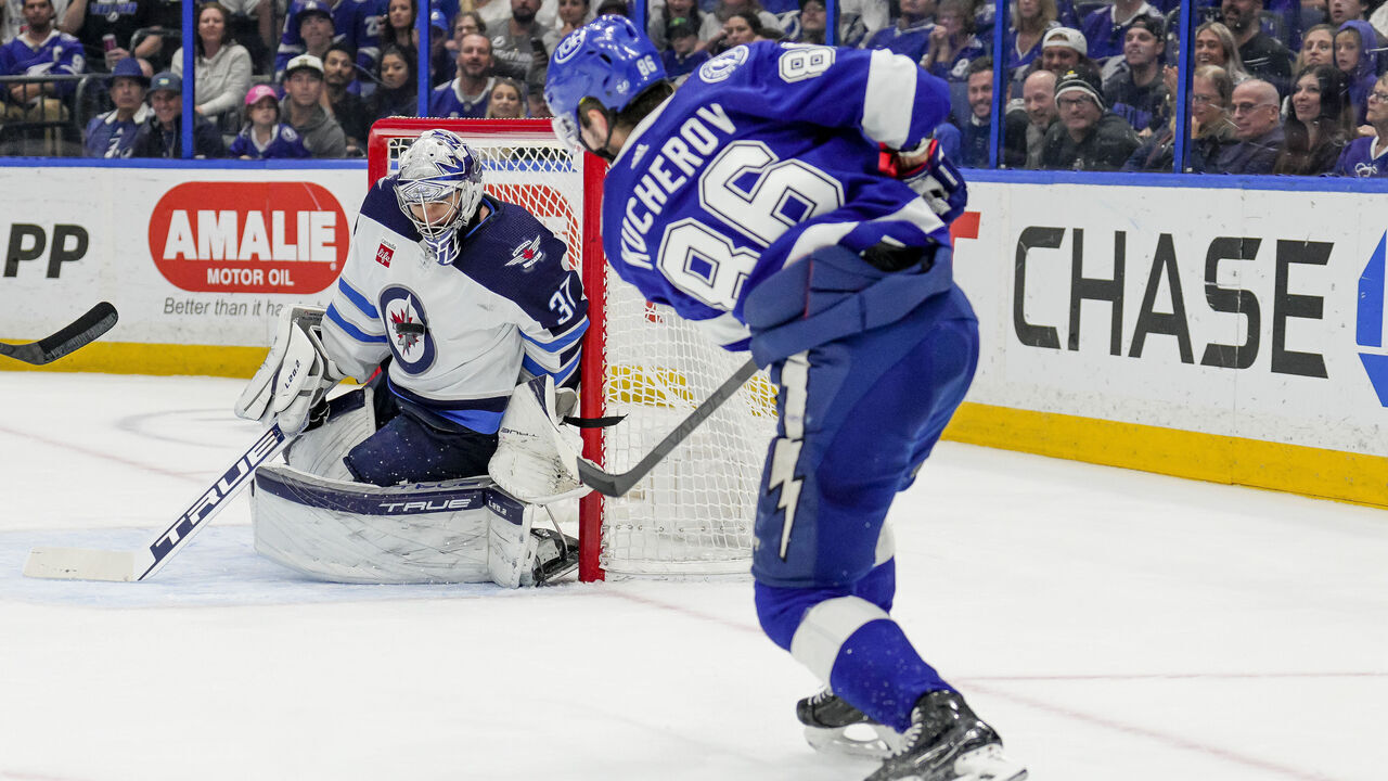 TAMPA, FL - MARCH 12: Tampa Bay Lightning right wing Nikita Kucherov (86) shoots and hits Winnipeg Jets goaltender Connor Hellebuyck (37) in the Winnipeg Jets chest logo during the NHL Hockey match between the Tampa Bay Lightning and Winnipeg Jets on March 12th, 2023 at Amalie Arena in Tampa, FL.