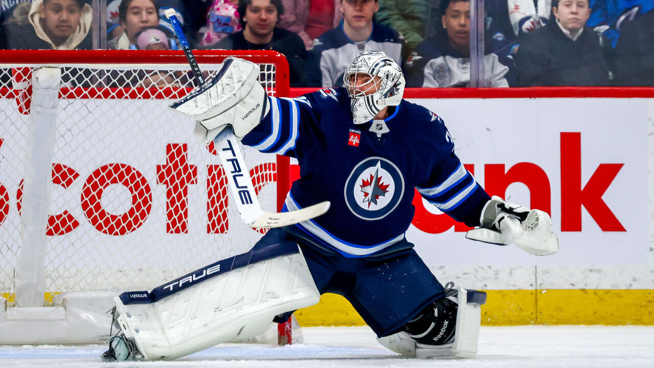 WINNIPEG, CANADA - MARCH 30: Goaltender Connor Hellebuyck #37 of the Winnipeg Jets reacts to a shot during second period action against the Vancouver Canucks at Canada Life Centre on March 30, 2025 in Winnipeg, Manitoba, Canada.