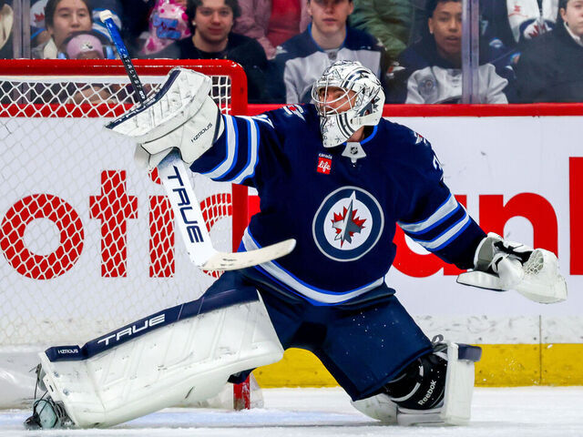 WINNIPEG, CANADA - MARCH 30: Goaltender Connor Hellebuyck #37 of the Winnipeg Jets reacts to a shot during second period action against the Vancouver Canucks at Canada Life Centre on March 30, 2025 in Winnipeg, Manitoba, Canada.