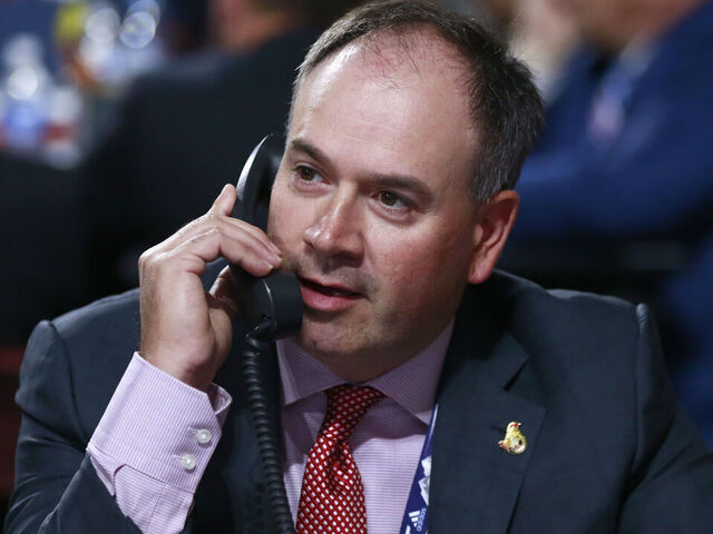 VANCOUVER, BRITISH COLUMBIA - JUNE 22: General manager Pierre Dorion of the Ottawa Senators talks on the phone on the draft floor during Rounds 2-7 of the 2019 NHL Draft at Rogers Arena on June 22, 2019 in Vancouver, Canada.