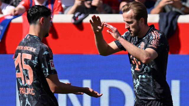 Bayern Munich's English forward #09 Harry Kane (R) celebrates scoring the opening goal with his teammate German midfielder #45 Aleksandar Pavlovic during the German first division Bundesliga football match between Heidenheim and Bayern Munich in Heidenheim, southern Germany on April 19, 2025.