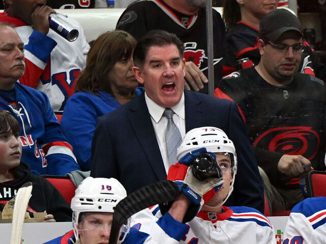RALEIGH, NC - APRIL 12: New York Rangers head coach Peter Laviolette calls to officials during the NHL game between the New York Rangers and the Carolina Hurricanes on April 12, 2025 at Lenovo Center in Raleigh, North Carolina.