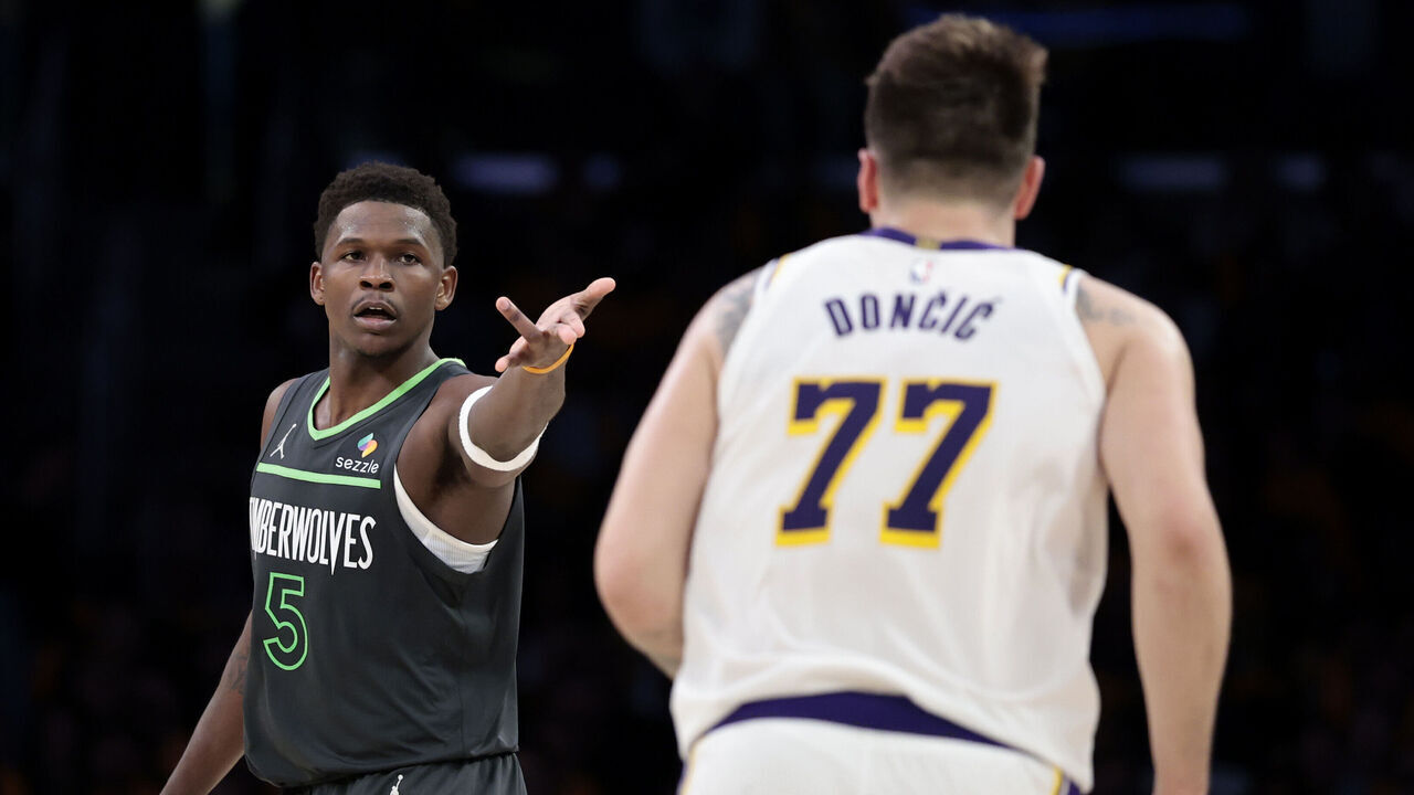 LOS ANGELES, CALIFORNIA - APRIL 19: Anthony Edwards #5 of the Minnesota Timberwolves reacts in front of Luka Doncic #77 of the Los Angeles Lakers during the fourth quarter in Game One of the Western Conference First Round NBA Playoffs at Crypto.com Arena on April 19, 2025 in Los Angeles, California.