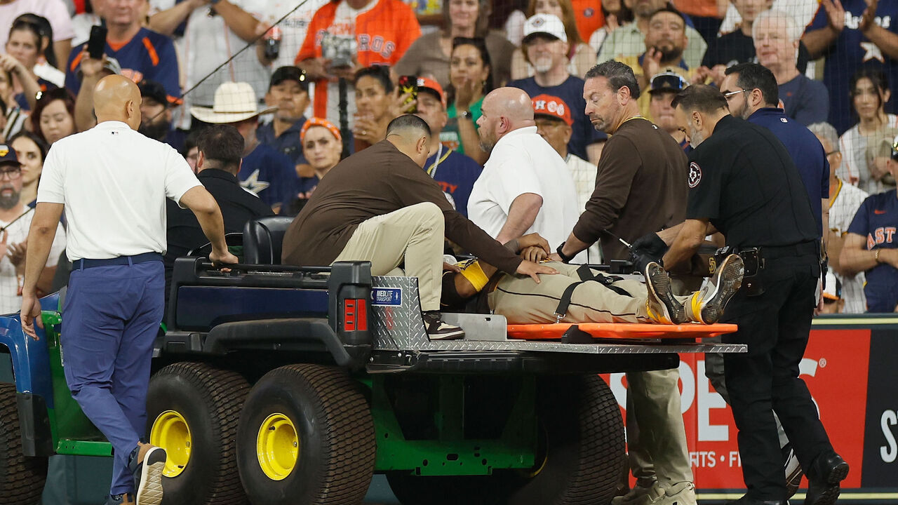 HOUSTON, TEXAS - APRIL 20: Luis Arraez #4 of the San Diego Padres is carted off the field after colliding with Mauricio Dubon in the first inning against the Houston Astros at Daikin Park on April 20, 2025 in Houston, Texas.