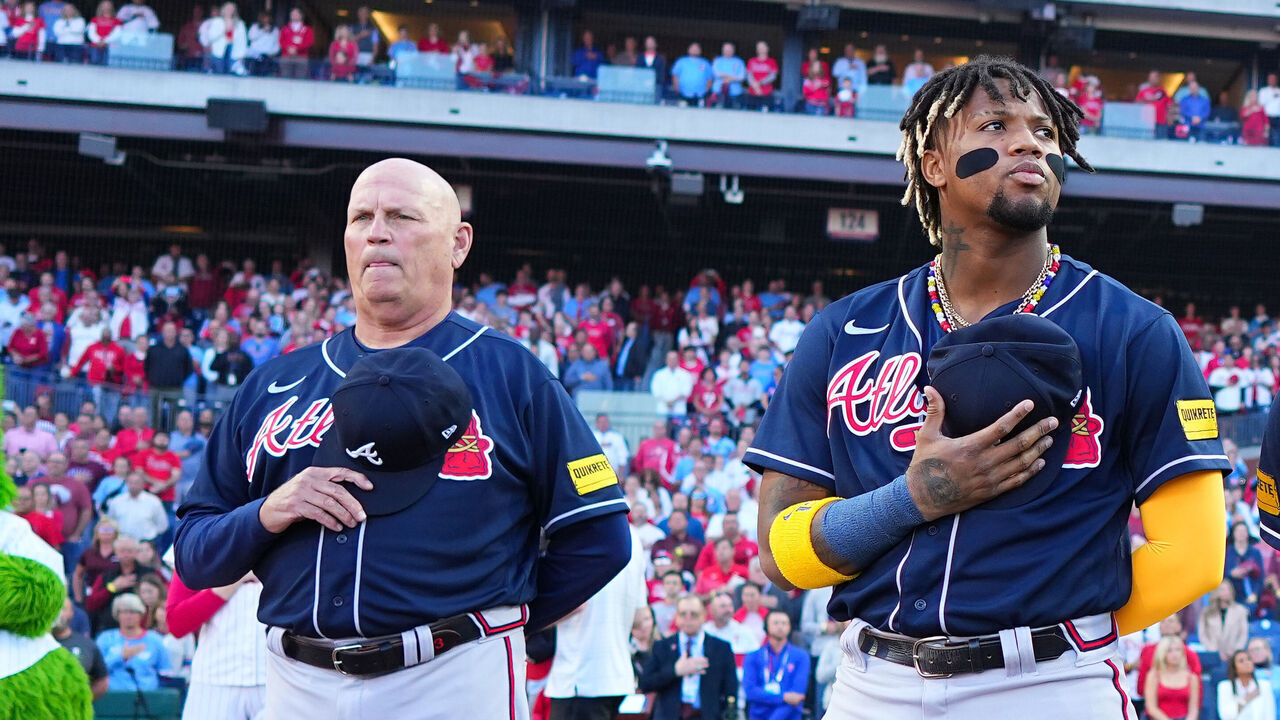 PHILADELPHIA, PA - OCTOBER 11: Brian Snitker and Ronald Acuna Jr. #13, Ozzie Albies #1 and Austin Riley #27 of the Atlanta Braves line the basepath during the national anthem prior to Game 3 of the Division Series between the Atlanta Braves and the Philadelphia Phillies at Citizens Bank Park on Wednesday, October 11, 2023 in Philadelphia, Pennsylvania.