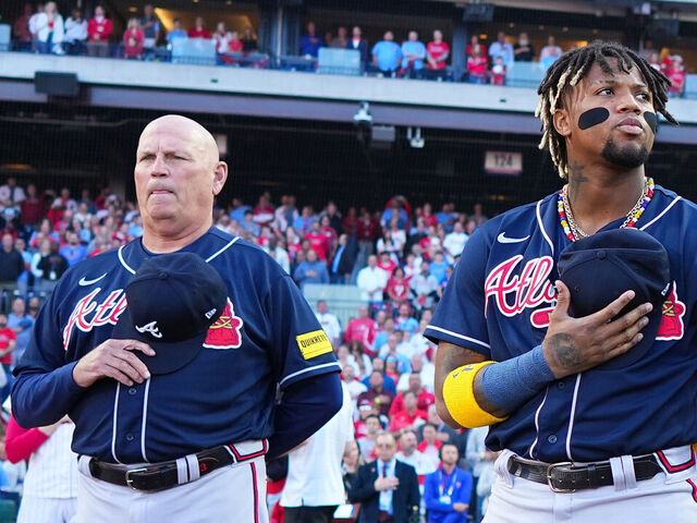 PHILADELPHIA, PA - OCTOBER 11: Brian Snitker and Ronald Acuna Jr. #13, Ozzie Albies #1 and Austin Riley #27 of the Atlanta Braves line the basepath during the national anthem prior to Game 3 of the Division Series between the Atlanta Braves and the Philadelphia Phillies at Citizens Bank Park on Wednesday, October 11, 2023 in Philadelphia, Pennsylvania.