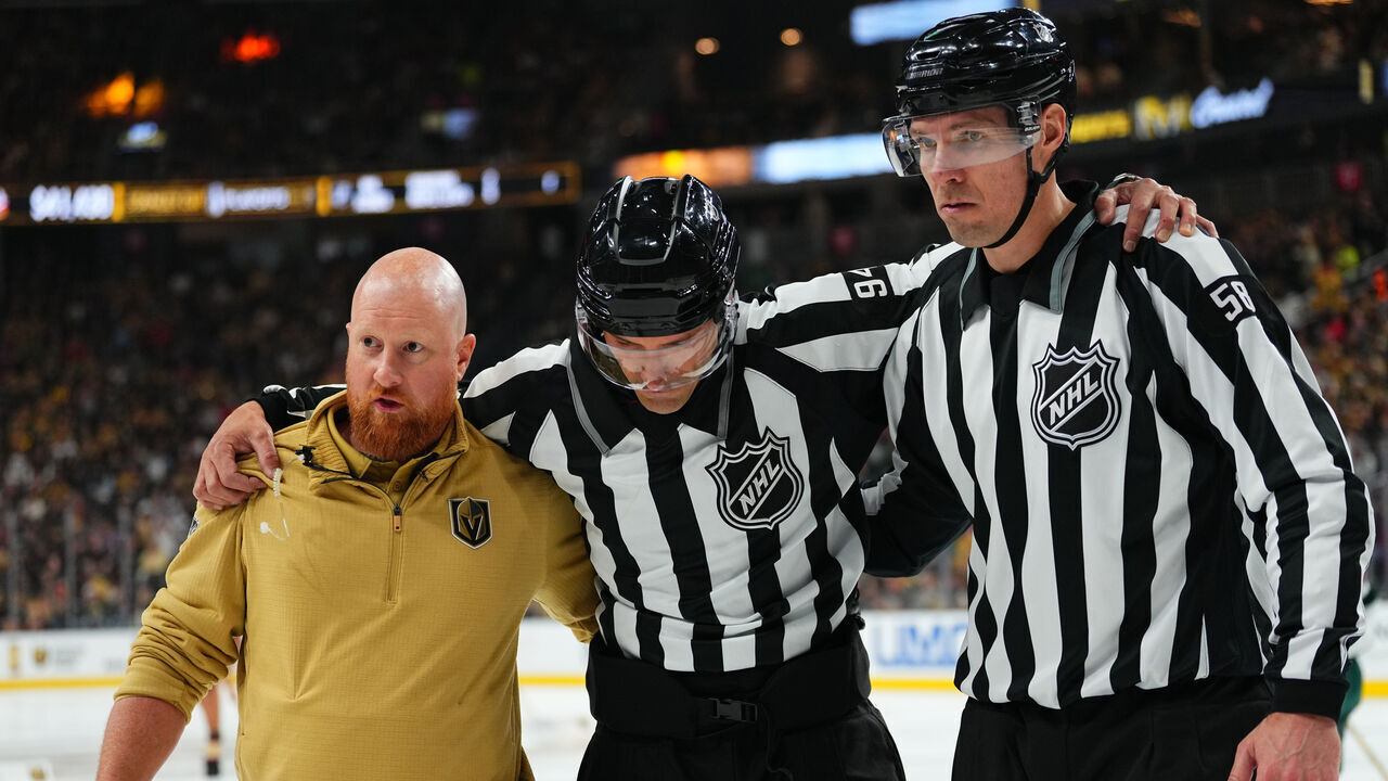 LAS VEGAS, NEVADA - APRIL 20: Linesman Bryan Pancich #94 is helped off the ice after suffering an injury during the second period of Game One of the First Round of the 2025 Stanley Cup Playoffs between the Vegas Golden Knights and the Minnesota Wild at T-Mobile Arena on April 20, 2025 in Las Vegas, Nevada.
