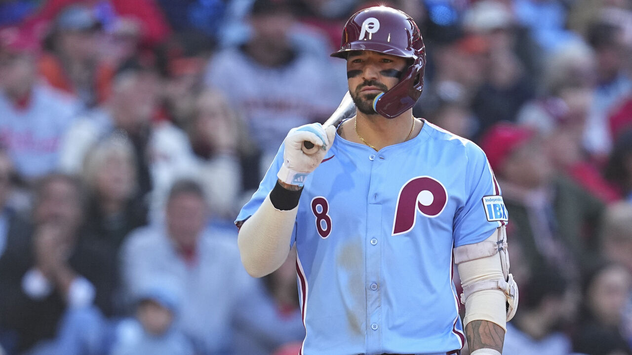 Nick Castellanos stands focused at the plate during a Phillies game, bat in hand and eyes locked in.