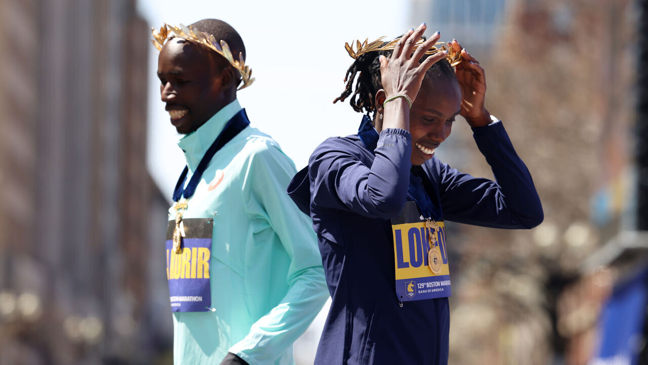 BOSTON, MA - April 21: Women's winner Sharon Lokedi and men's winner John Korir crossed paths after posing together for a portrait on the finish line of the 129th Boston Marathon on April 21, 2025.