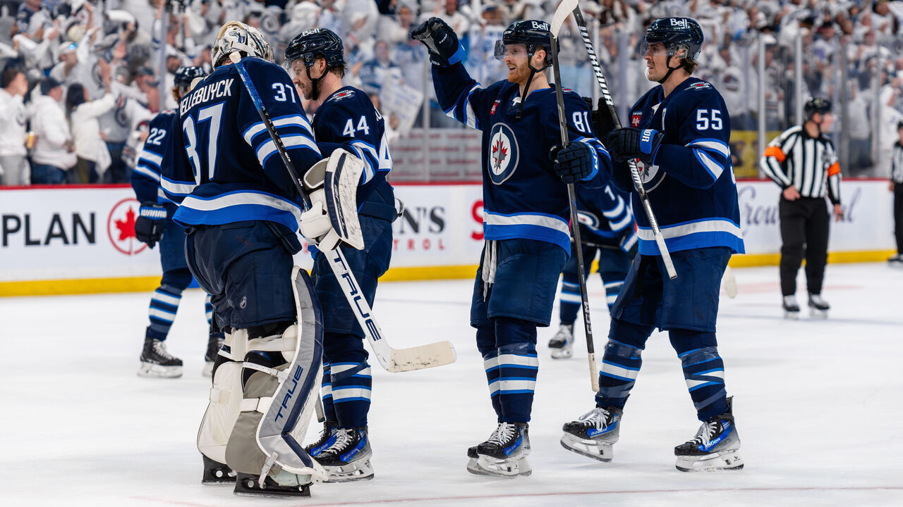 WINNIPEG, CANADA - APRIL 21: Connor Hellebuyck #37 of the Winnipeg Jets celebrates with Josh Morrissey #44, Kyle Connor #81 and Mark Scheifele #55 after their 2-1 victory against the St. Louis Blues for a 2-0 series lead in the First Round of the 2025 Stanley Cup Playoffs at Canada Life Centre on April 21, 2025 in Winnipeg, Canada. The Jets defeated the Blues 2-1.