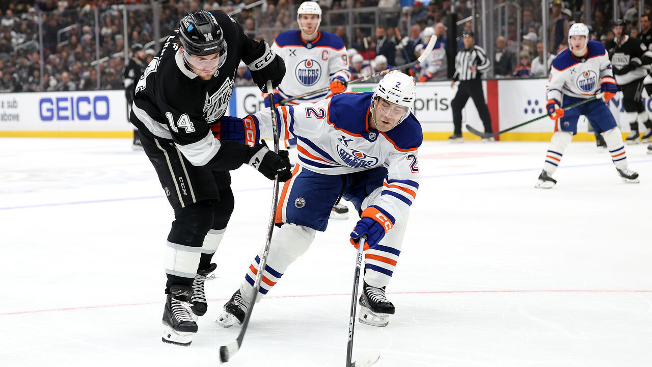 LOS ANGELES, CALIFORNIA - APRIL 21: Alex Laferriere #14 of the Los Angeles Kings shoots the puck as Evan Bouchard #2 of the Edmonton Oilers defends during the second period in Game One of the First Round of the 2025 Stanley Cup Playoffs at Crypto.com Arena on April 21, 2025 in Los Angeles, California.
