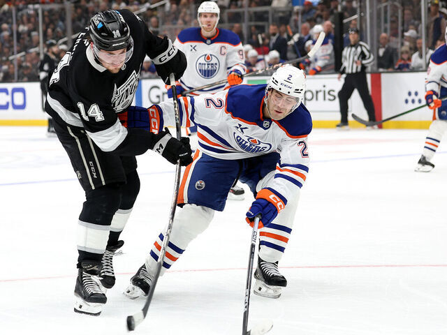 LOS ANGELES, CALIFORNIA - APRIL 21: Alex Laferriere #14 of the Los Angeles Kings shoots the puck as Evan Bouchard #2 of the Edmonton Oilers defends during the second period in Game One of the First Round of the 2025 Stanley Cup Playoffs at Crypto.com Arena on April 21, 2025 in Los Angeles, California.