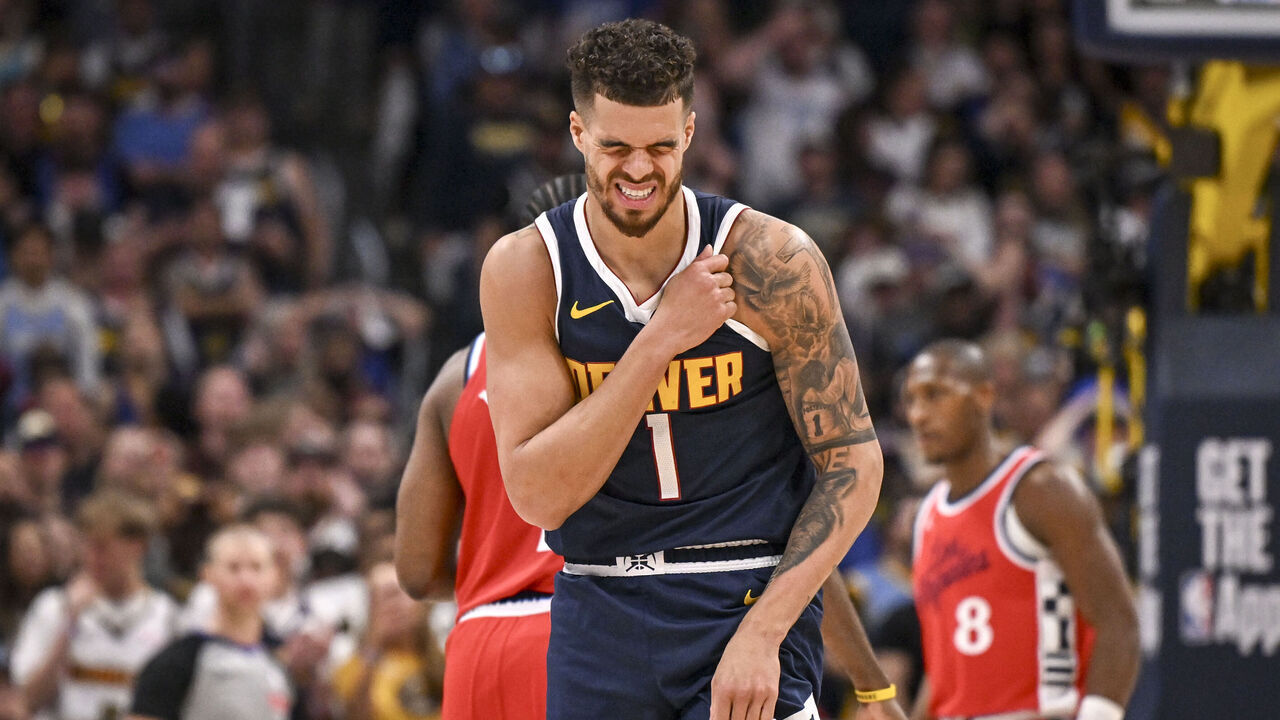 DENVER, CO - APRIL 21: Michael Porter Jr. (1) of the Denver Nuggets winces after a scramble for a loose ball against Kris Dunn (8) of the LA Clippers ended up on the ground during the fourth quarter of the Clippers' 105-102 win at Ball Arena in Denver, Colorado on Monday, April 21, 2025.