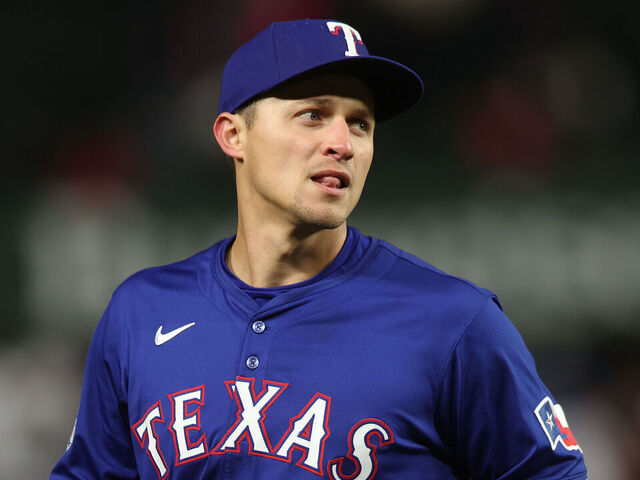 CHICAGO, ILLINOIS - APRIL 8: Corey Seager #5 of the Texas Rangers fields a ball during a game against the Chicago Cubs at Wrigley Field on April 8, 2025 in Chicago, Illinois.