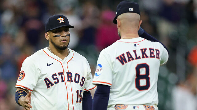 HOUSTON, TEXAS - APRIL 22: Isaac Paredes #15 and Christian Walker #8 of the Houston Astros shake hands after defeating the Toronto Blue Jays at Daikin Park on April 22, 2025 in Houston, Texas.