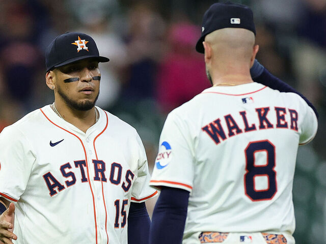 HOUSTON, TEXAS - APRIL 22: Isaac Paredes #15 and Christian Walker #8 of the Houston Astros shake hands after defeating the Toronto Blue Jays at Daikin Park on April 22, 2025 in Houston, Texas.