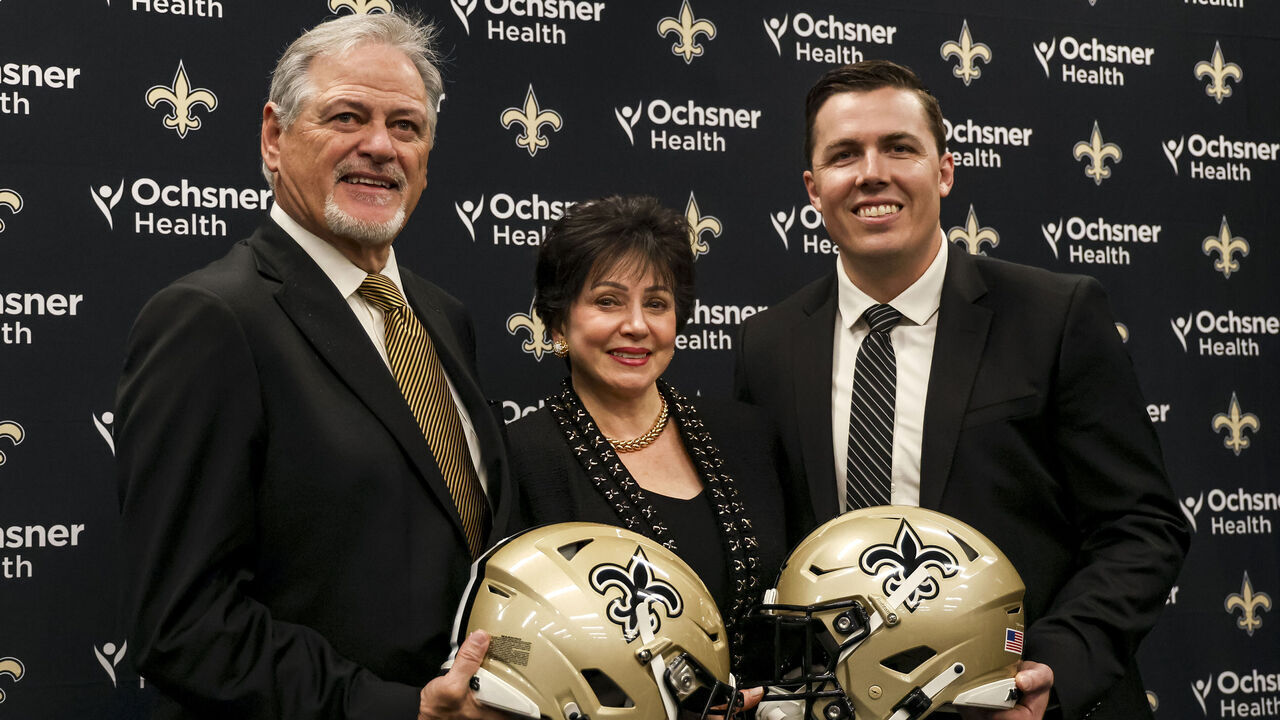 METAIRIE, LOUISIANA - FEBRUARY 13: Newly named head coach Kellen Moore of the New Orleans Saints poses with executive vice president and general manager Mickey Loomis and owner Gayle Benson during a introductory press conference at the Ochsner Sports Performance Center on February 13, 2025 in Metairie, Louisiana.
