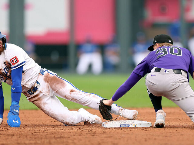 KANSAS CITY, MISSOURI - APRIL 24: Bobby Witt Jr. #7 of the Kansas City Royals looks back at Aaron Schunk #30 of the Colorado Rockies as he steals second base during game two of a double-header at Kauffman Stadium on April 24, 2025 in Kansas City, Missouri.