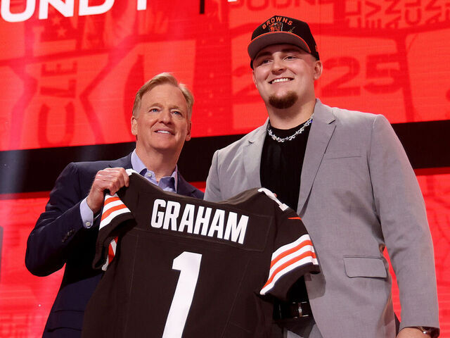 GREEN BAY, WISCONSIN - APRIL 24: Defensive Tackle Mason Graham of Michigan poses with NFL Commissioner Roger Goodell after being selected fifth overall pick by the Cleveland Browns during the first round of the 2025 NFL Draft at Lambeau Field on April 24, 2025 in Green Bay, Wisconsin.