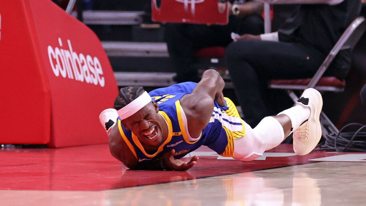 Golden State Warriors' Jimmy Butler III writhes in pain after injuring himself in 1st quarter against Houston Rockets in Game 2 of First Round of NBA Playoffs at Toyota Center in Houston, Texas on Wednesday, April 23, 2025.
