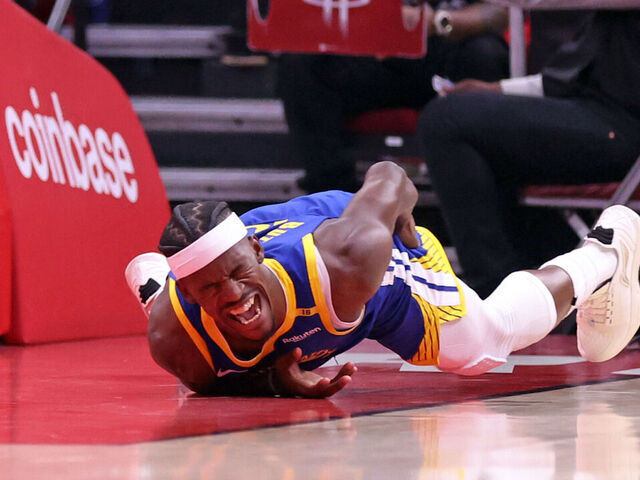 Golden State Warriors' Jimmy Butler III writhes in pain after injuring himself in 1st quarter against Houston Rockets in Game 2 of First Round of NBA Playoffs at Toyota Center in Houston, Texas on Wednesday, April 23, 2025.