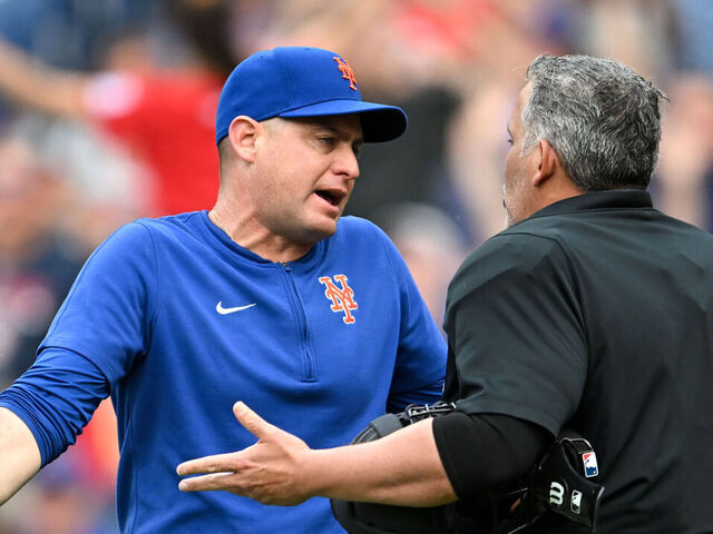 CLEVELAND, OHIO - MAY 20, 2024: Manager Carlos Mendoza #64 of the New York Mets argues with home plate umpire Manny Gonzalez, after Gonzalez ejected Starling Marte during the fourth inning against the Cleveland Guardians at Progressive Field on May 20, 2024 in Cleveland, Ohio.