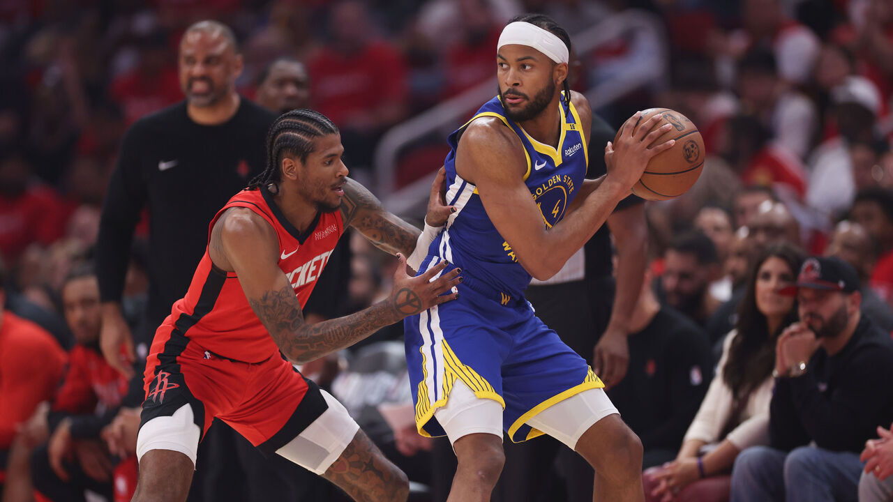 HOUSTON, TEXAS - APRIL 23: Moses Moody #4 of the Golden State Warriors controls the ball against Jalen Green #4 of the Houston Rockets in the first half in Game Two of the Western Conference First Round NBA Playoffs at Toyota Center on April 23, 2025 in Houston, Texas.