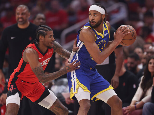 HOUSTON, TEXAS - APRIL 23: Moses Moody #4 of the Golden State Warriors controls the ball against Jalen Green #4 of the Houston Rockets in the first half in Game Two of the Western Conference First Round NBA Playoffs at Toyota Center on April 23, 2025 in Houston, Texas.