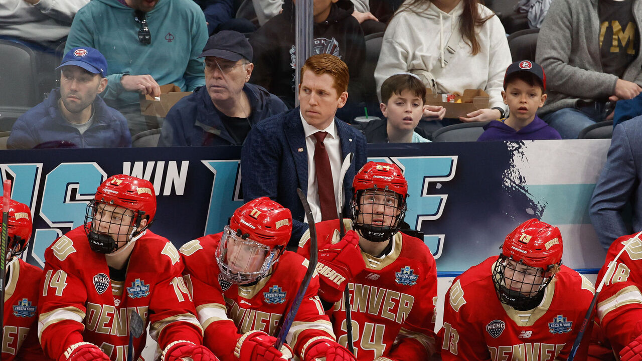 ST. LOUIS, MISSOURI - APRIL 10: Head Coach David Carle of the Denver Pioneers stands behind the bench area during a game against the Western Michigan Broncos in the second period during the NCAA Men's Hockey Frozen Four semifinal at the Enterprise Center on April 10, 2025 in St. Louis, Missouri. The Broncos won 3-2 in double overtime.
