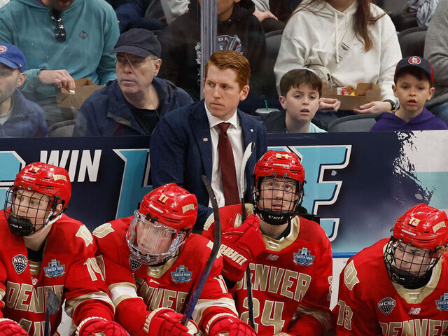 ST. LOUIS, MISSOURI - APRIL 10: Head Coach David Carle of the Denver Pioneers stands behind the bench area during a game against the Western Michigan Broncos in the second period during the NCAA Men's Hockey Frozen Four semifinal at the Enterprise Center on April 10, 2025 in St. Louis, Missouri. The Broncos won 3-2 in double overtime.