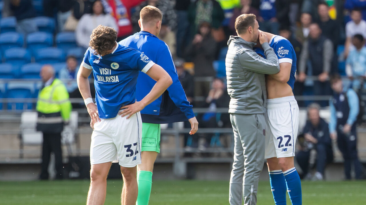 CARDIFF, WALES - APRIL 26: Ollie Tanner (L) and Yousef Salech of Cardiff City (R) react at full time as they get relegated to League One during the Sky Bet Championship match between Cardiff City and West Bromwich Albion at the Cardiff City Stadium on April 26, 2025 in Cardiff, Wales.