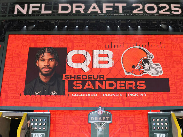 GREEN BAY, WISCONSIN - APRIL 26: A screen shows Colorado quarterback Shedeur Sanders' name after being selected by the Cleveland Browns with the 144th overall pick during the fifth round of the 2025 NFL Draft on April 26, 2025 in Green Bay, Wisconsin.