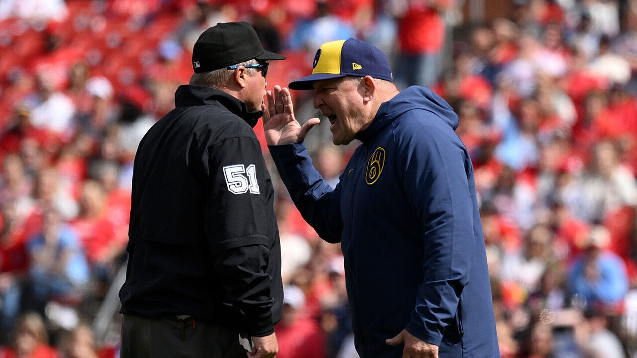 ST LOUIS, MISSOURI - APRIL 26: Pat Murphy #49 of the Milwaukee Brewers talks with umpire Marvin Hudson #51after a call during the seventh inning at Busch Stadium on April 26, 2025 in St Louis, Missouri.