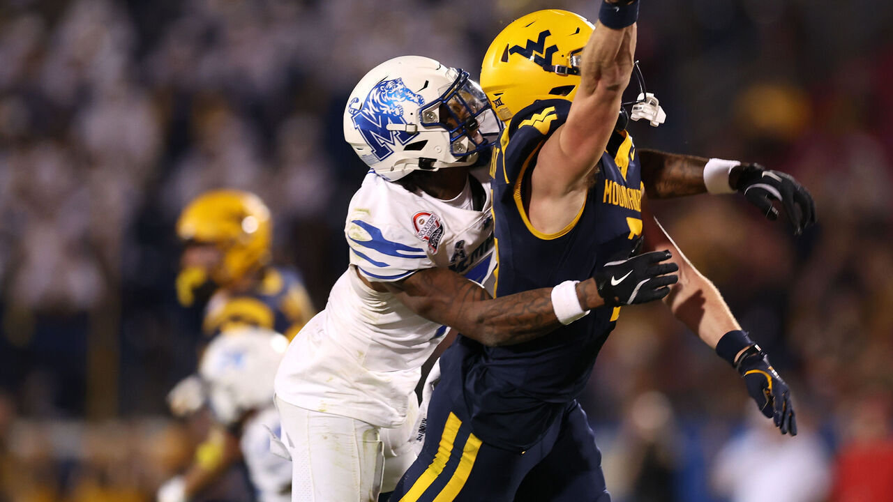 FRISCO, TEXAS - DECEMBER 17: Hudson Clement #3 of the West Virginia Mountaineers is defended by Kobee Minor #7 of the Memphis Tigers during the second half of the Scooter's Coffee Frisco Bowl at Toyota Stadium on December 17, 2024 in Frisco, Texas.