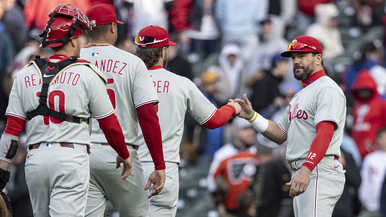 CHICAGO, ILLINOIS - APRIL 26: Kyle Schwarber #12 of the Philadelphia Phillies high-fives teammates after defeating the Chicago Cubs 10- at Wrigley Field on April 26, 2025 in Chicago, Illinois.