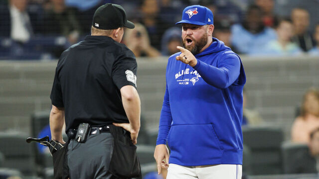 TORONTO, CANADA - APRIL 17: John Schneider, manager of the Toronto Blue Jays yells at umpire Tom Hallion in the ninth inning of their MLB game against the New York Yankees at Rogers Centre on April 17, 2024 in Toronto, Canada.