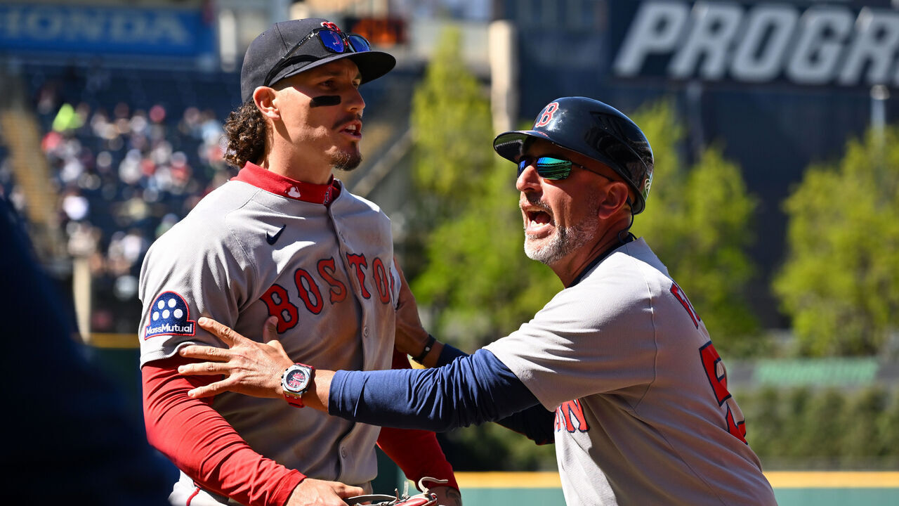 CLEVELAND, OHIO - APRIL 27: First base coach José David Flores #58 of the Boston Red Sox holds back Jarren Duran #16 as Duran yells at a fan during the seventh inning against the Cleveland Guardians at Progressive Field on April 27, 2025 in Cleveland, Ohio.