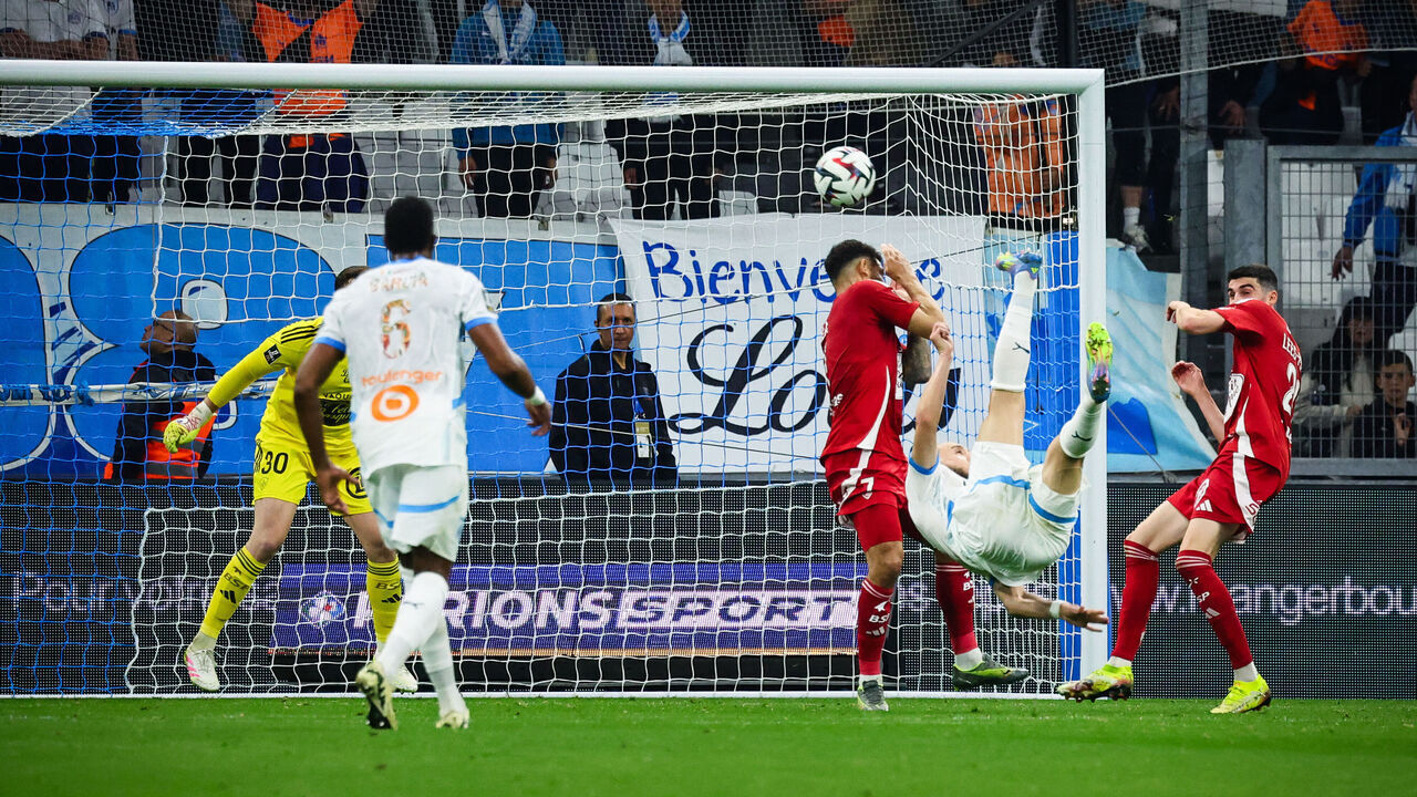 Marseille's Algerian forward #09 Amine Gouiri (2nd-L) kicks the ball and scores during the French L1 football match between Olympique de Marseille (OM) and Stade Brestois 29 (Brest) at Stade Velodrome in Marseille, southern France on April 27, 2025.