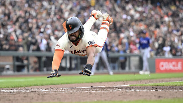 SAN FRANCISCO, CALIFORNIA - APRIL 27: Heliot Ramos #17 of the San Francisco Giants scores the game-winning run on his infield hit and throwing error to first base against the Texas Rangers in the ninth inning at Oracle Park on April 27, 2025 in San Francisco, California.