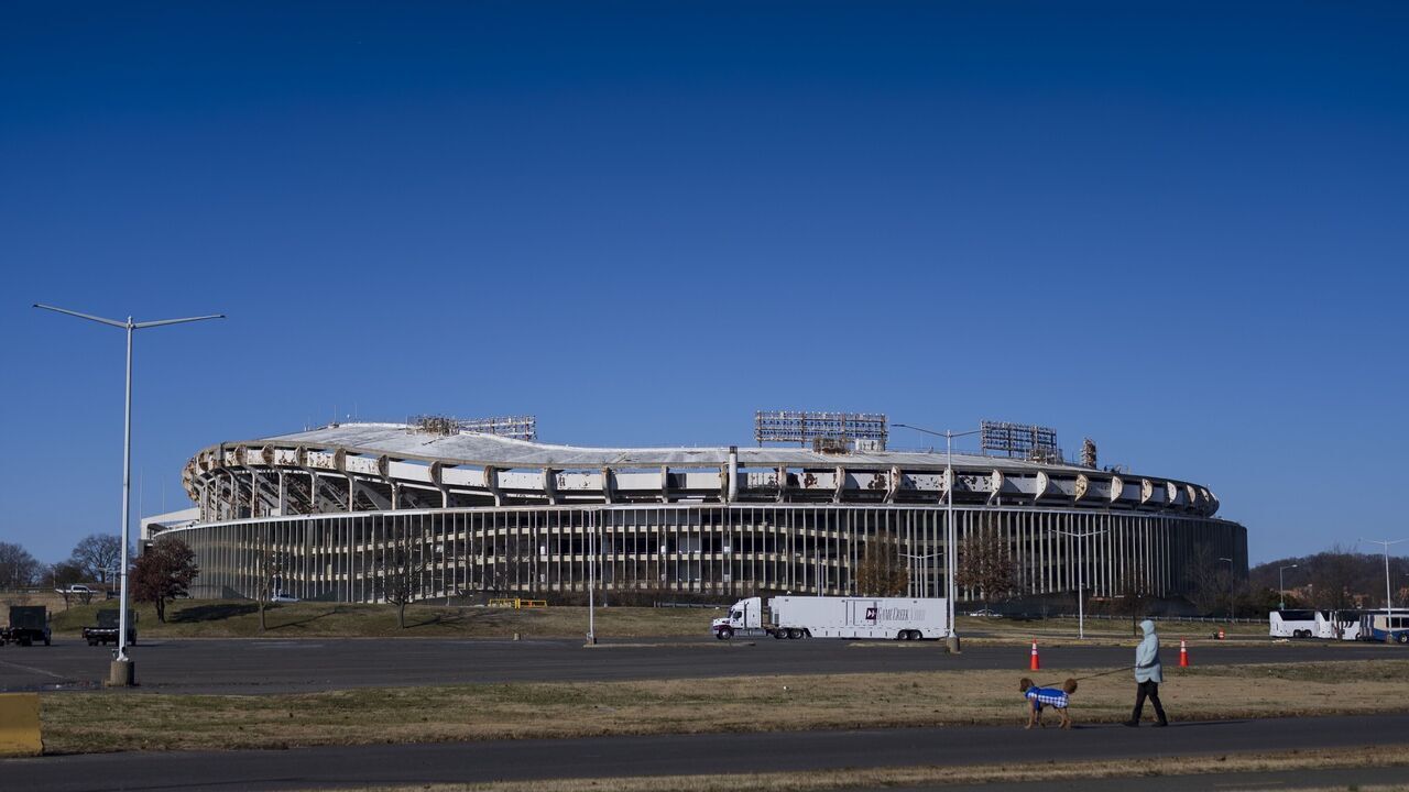 WASHINGTON, DC - DECEMBER 22: A person walks a dog near Robert F. Kennedy Stadium on December 22, 2024 in Washington, DC. The Robert F. Kennedy Memorial Stadium Campus Revitalization Act passed the U.S. Senate early December 21st.