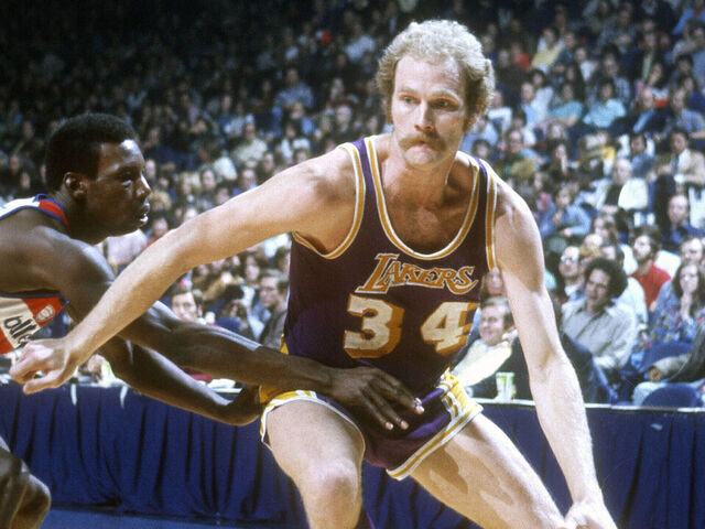 LANDOVER, MD - CIRCA 1975: Stan Love #34 of the Los Angeles Lakers dribbles the ball against the Washington Bullets during an NBA basketball game circa 1975 at the Capital Centre in Landover, Maryland. Love played for the Lakers from 1973-75.